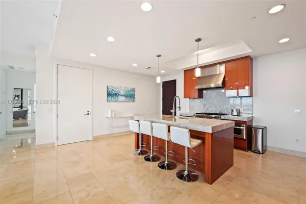a large white kitchen with stainless steel appliances