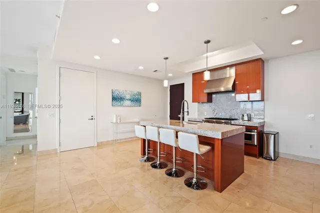 a large white kitchen with stainless steel appliances