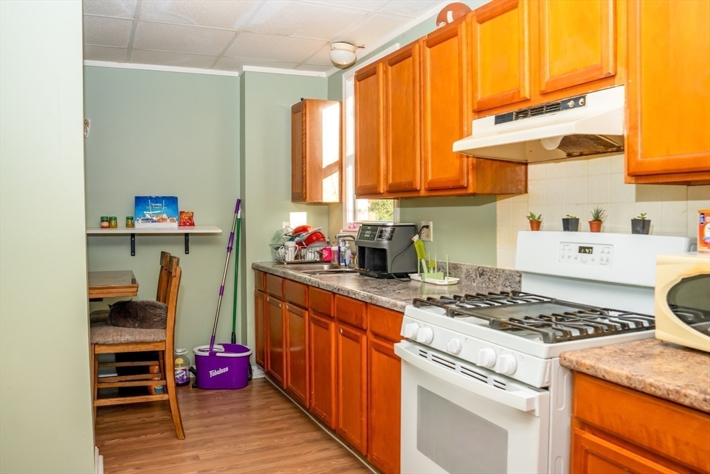 118 Jefferson Street Fall River, MA 02721 - Photo 16 of 34 a kitchen with a stove a sink and a refrigerator