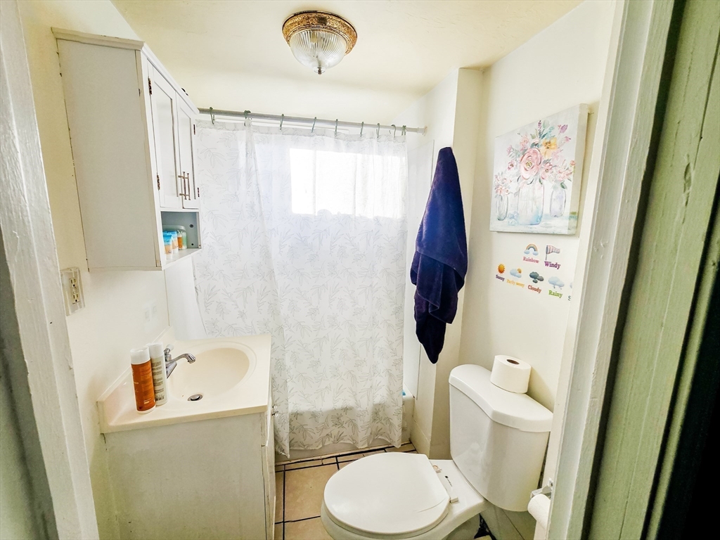 118 Jefferson Street Fall River, MA 02721 - Photo 19 of 34 a bathroom with a toilet sink and shower curtain