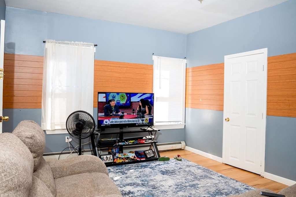 118 Jefferson Street Fall River, MA 02721 - Photo 31 of 34 a room with furniture and a flat screen tv