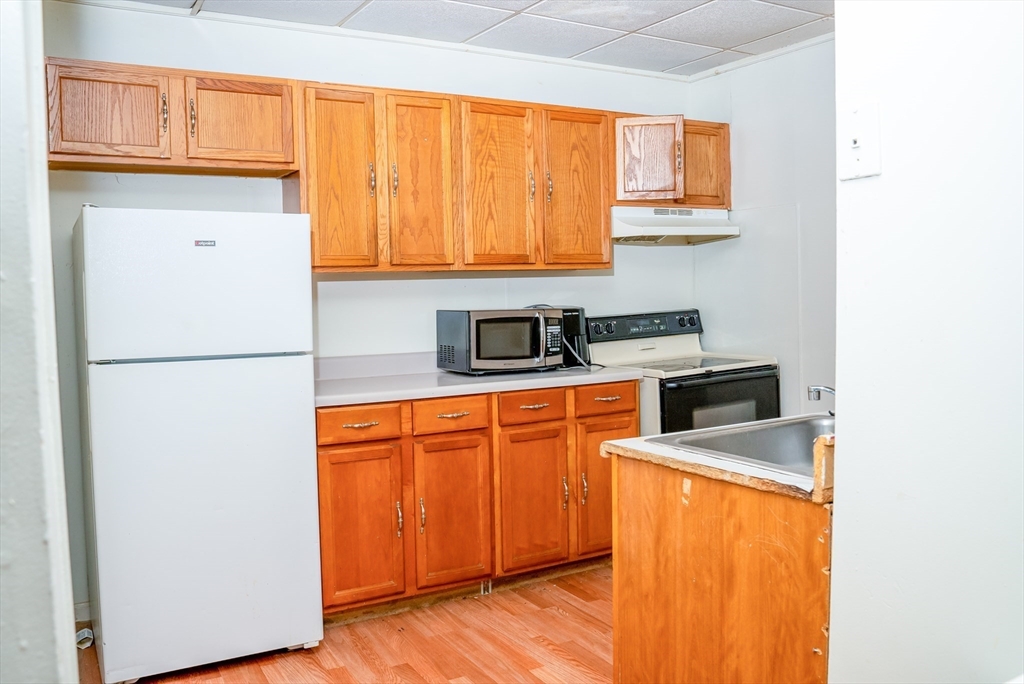 118 Jefferson Street Fall River, MA 02721 - Photo 4 of 34 a kitchen with stainless steel appliances granite countertop a refrigerator sink and cabinets