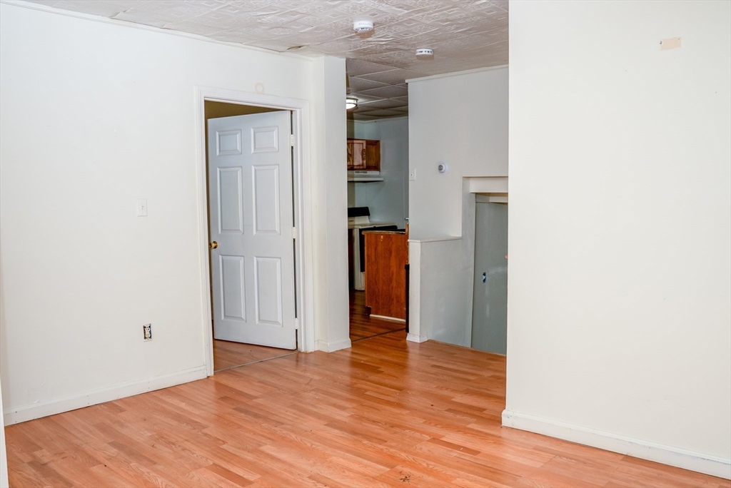 118 Jefferson Street Fall River, MA 02721 - Photo 5 of 34 a view of an empty room with wooden floor and closet