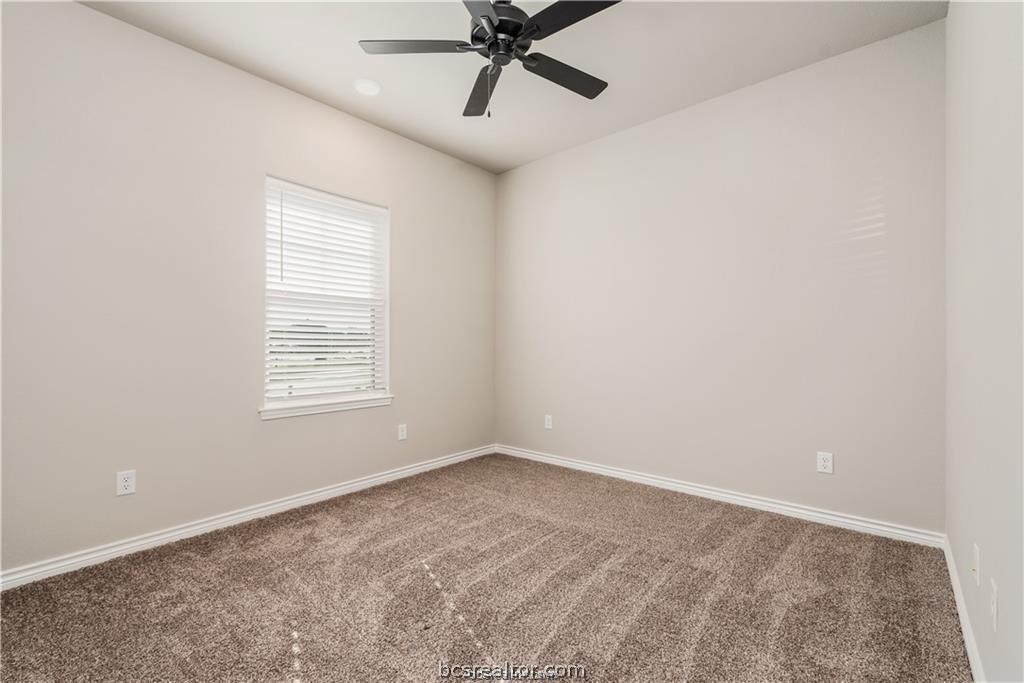 3185 Normandy Way Bryan, TX 77808 - Photo 12 of 16 an empty room with a window and a fan