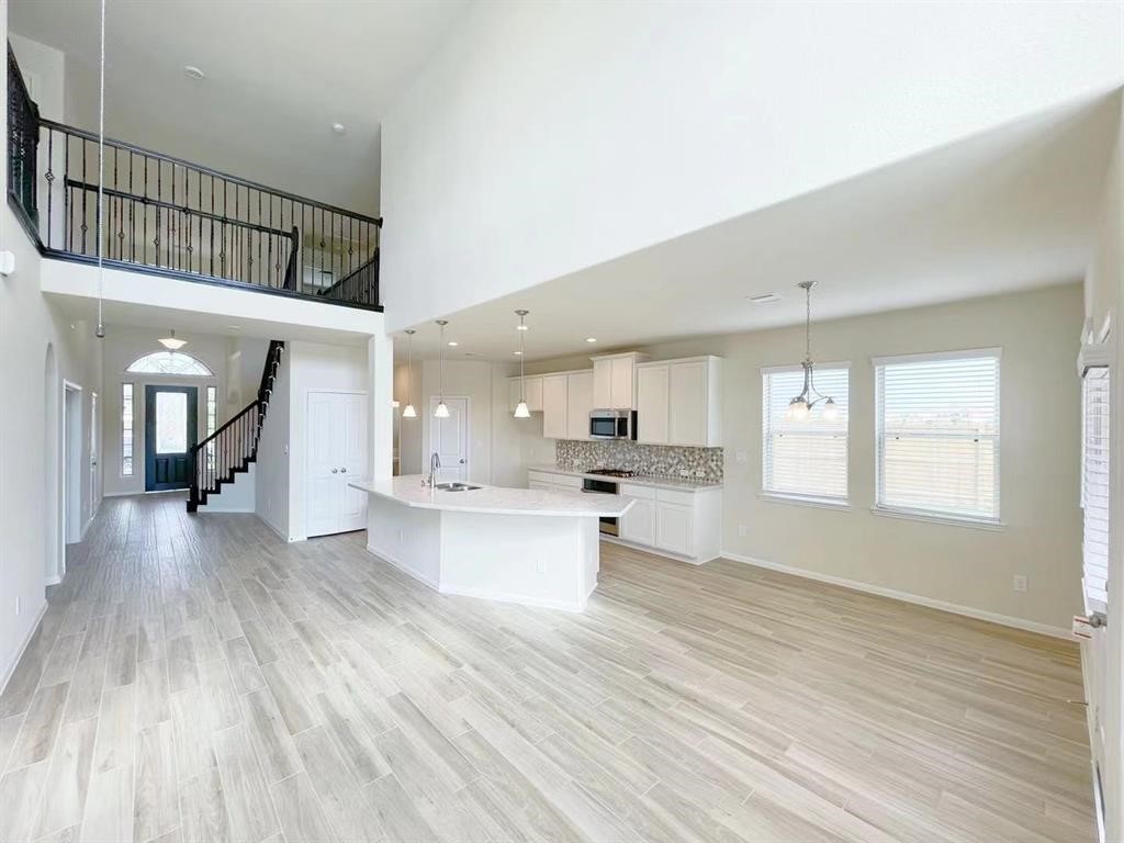 4403 Silvergrass Lane Katy, TX 77493 - Photo 12 of 26 a view of kitchen with sink microwave refrigerator and cabinets