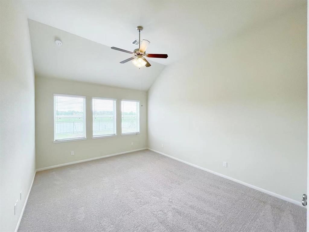 4403 Silvergrass Lane Katy, TX 77493 - Photo 13 of 26 a view of room with a ceiling fan and window