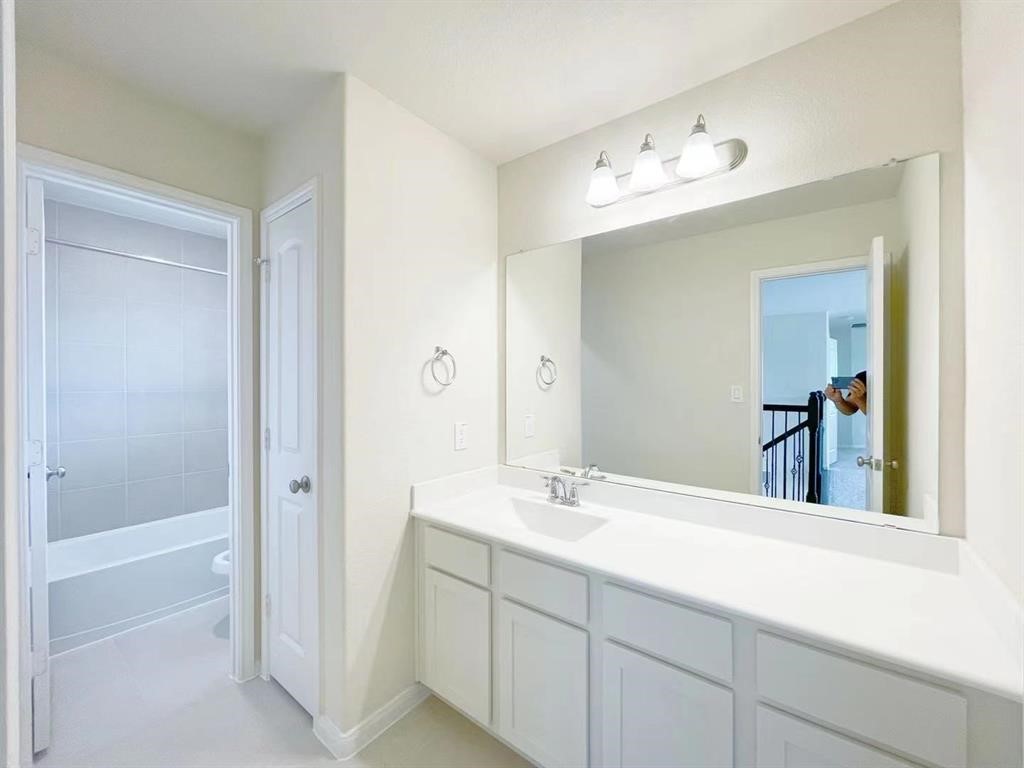 4403 Silvergrass Lane Katy, TX 77493 - Photo 19 of 26 a bathroom with a double vanity sink mirror and bathtub