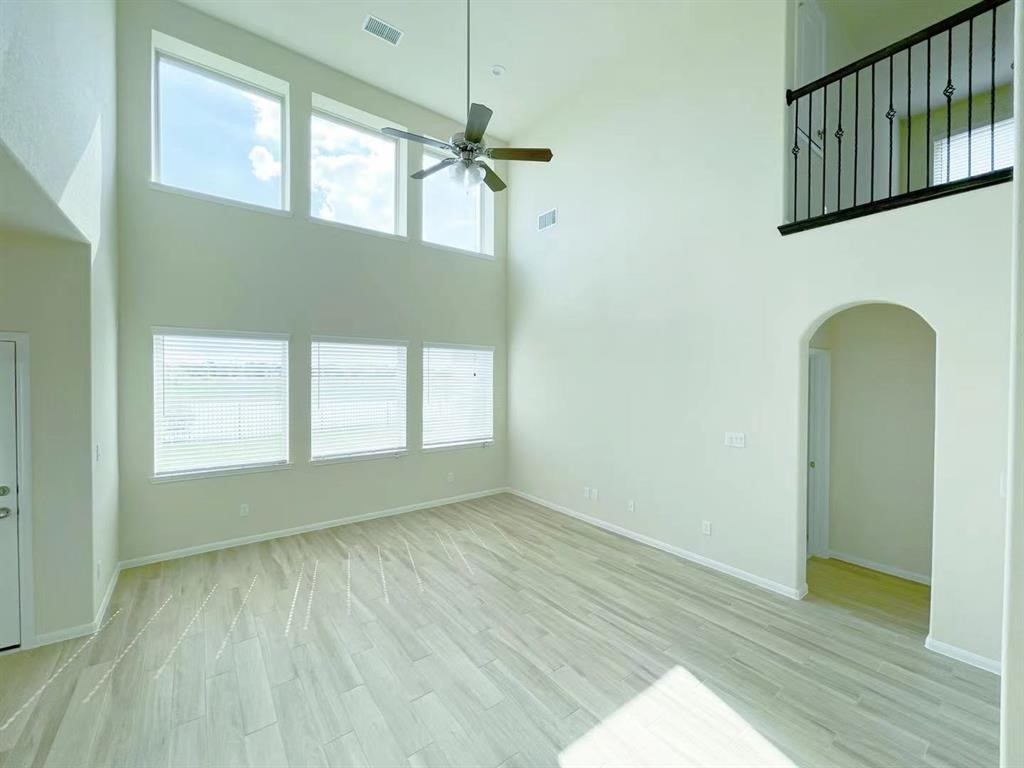 4403 Silvergrass Lane Katy, TX 77493 - Photo 6 of 26 a view of empty room with wooden floor and fan