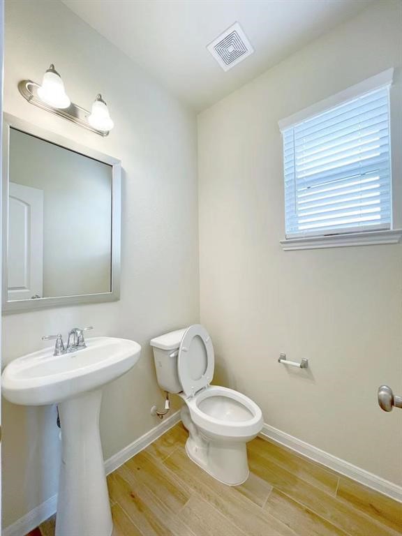 4403 Silvergrass Lane Katy, TX 77493 - Photo 7 of 26 a bathroom with a toilet sink and mirror