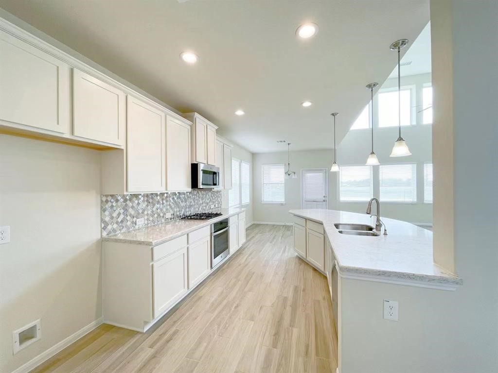 4403 Silvergrass Lane Katy, TX 77493 - Photo 8 of 26 a kitchen with stainless steel appliances granite countertop a sink stove and cabinets