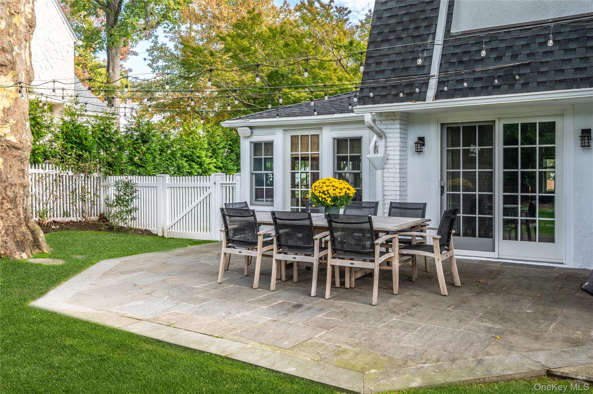 123 Ellison Avenue Bronxville, NY 10708 - Photo 21 of 27 a view of a house with backyard sitting area and garden