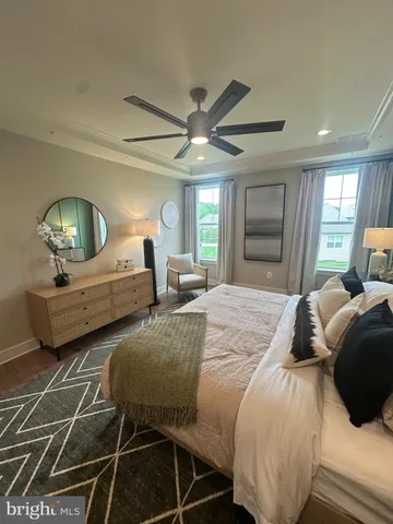 a bedroom with double bed and a chandelier