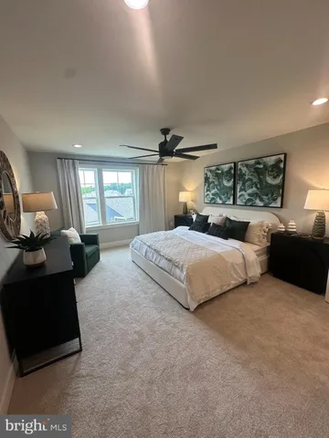 a bedroom with a bed mirror and window