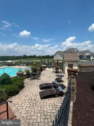 a view of a patio with chair and tables