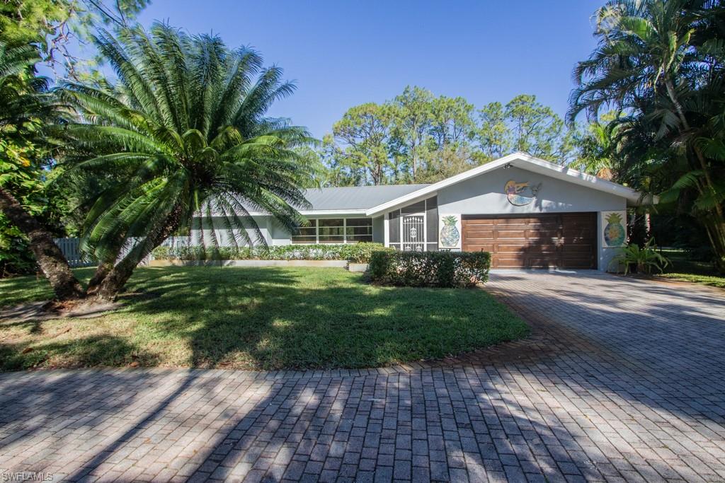 4525 North Road Naples, FL 34104 - Photo 1 of 33 a front view of a house with a yard