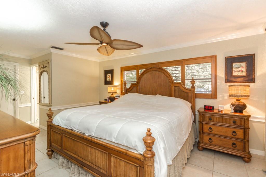 4525 North Road Naples, FL 34104 - Photo 12 of 33 a bedroom with a bed and wooden floor