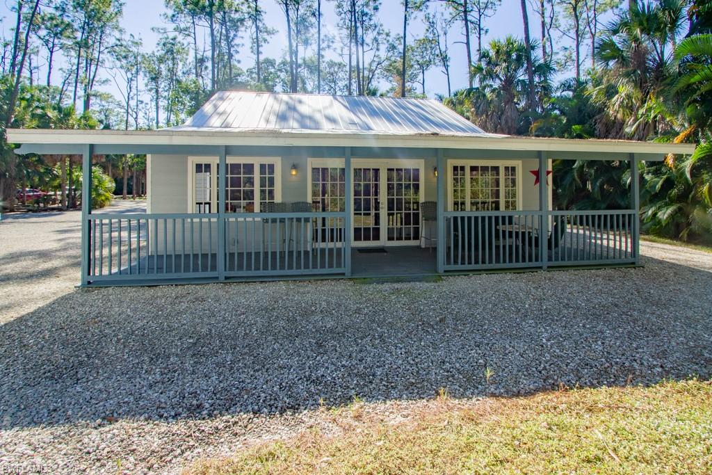 4525 North Road Naples, FL 34104 - Photo 29 of 33 a view of a house with a small yard and wooden fence