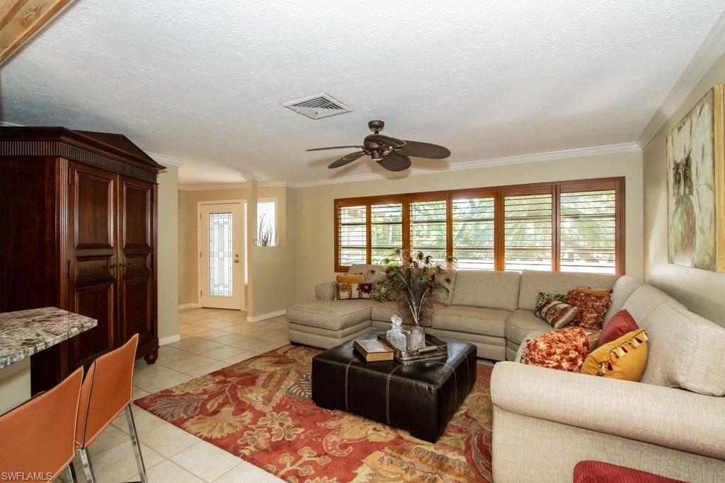 4525 North Road Naples, FL 34104 - Photo 4 of 33 a living room with furniture and a large window