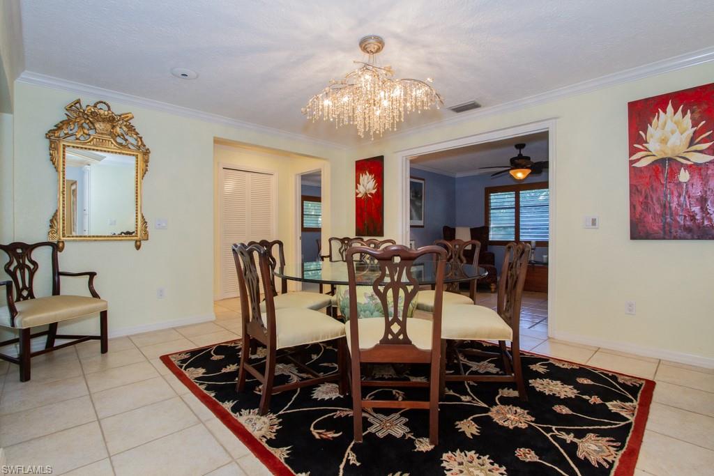 4525 North Road Naples, FL 34104 - Photo 9 of 33 a view of a dining room with furniture and chandelier