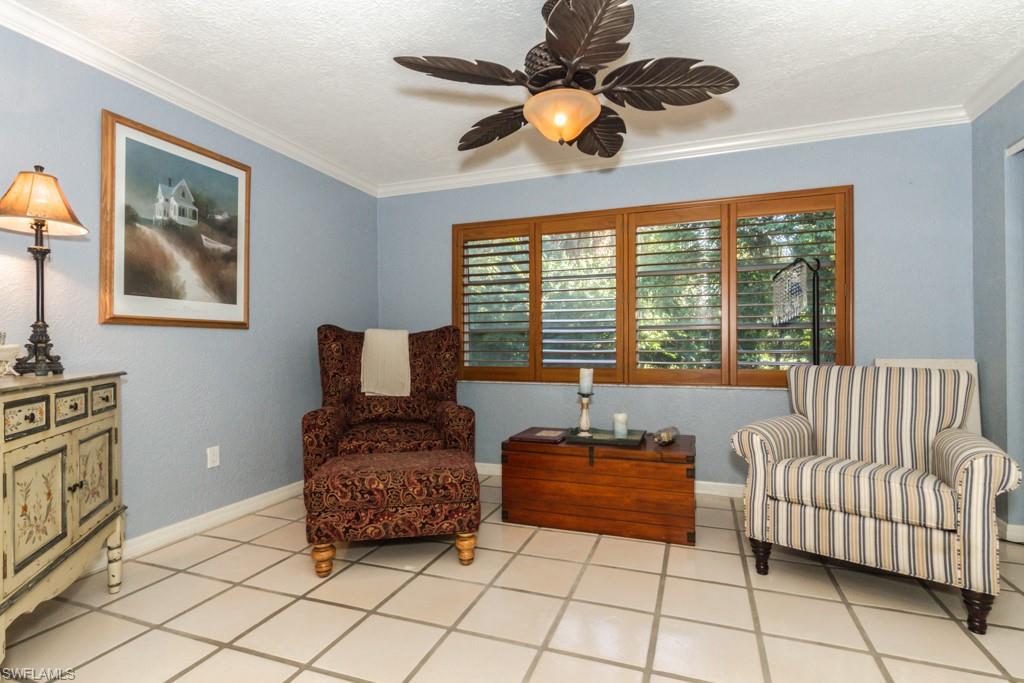 4525 North Road Naples, FL 34104 - Photo 10 of 33 a living room with furniture and a floor to ceiling window