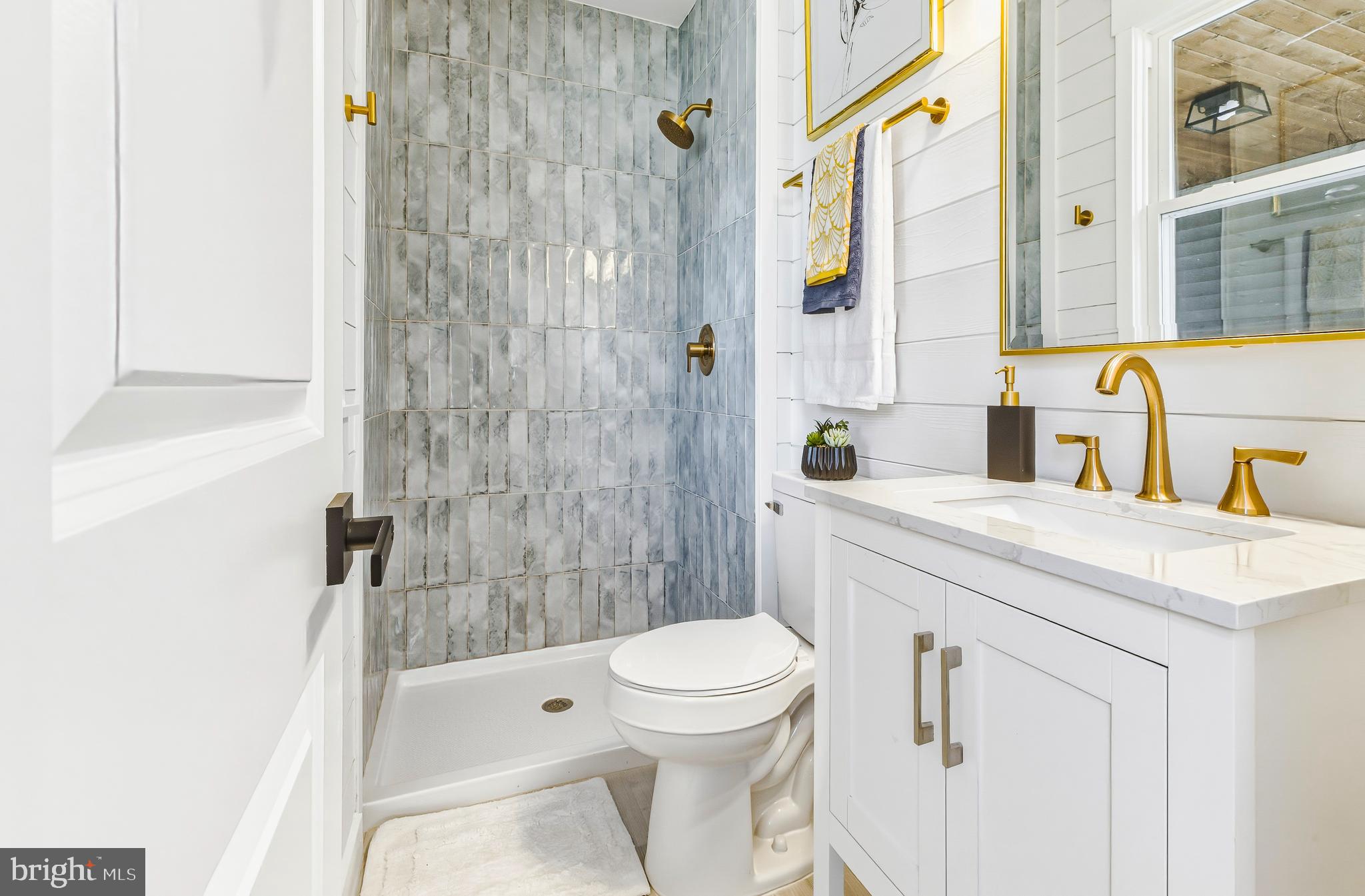 451 Alcyon Boulevard Pitman, NJ 08071 - Photo 23 of 32 a bathroom with a sink a toilet and shower