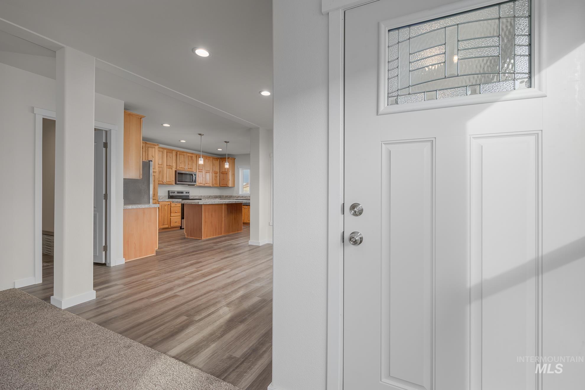 2750 Alden Road, Unit 8 8 Fruitland, ID 83619 - Photo 9 of 31 Kitchen with hanging light fixtures, a center island, stainless steel appliances, dark wood-type flooring, and a breakfast bar