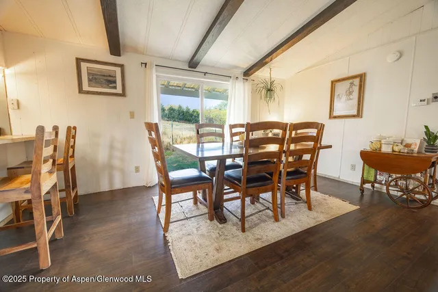 a bedroom with a bed a window and a flat screen television