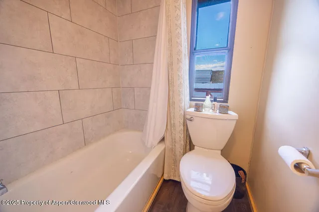 a view of a terrace with lawn chairs and iron fence