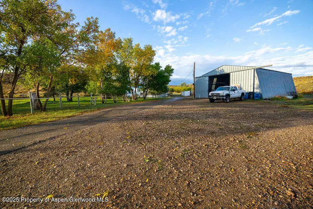 a view of a porch with furniture and a yard