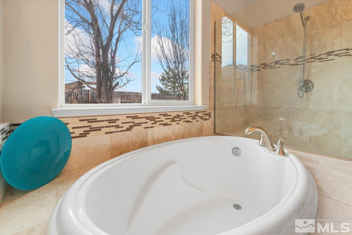 10245 Cavalry Circle Reno, NV 89521 - Photo 19 of 40 a bathroom with a tub and a shower