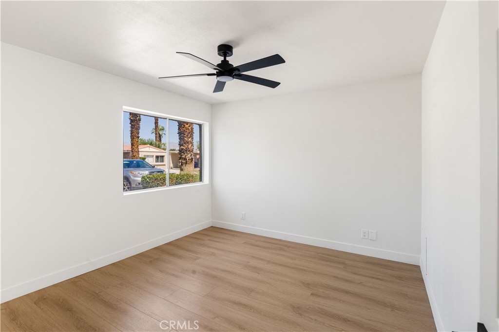 82151 Waring Way Indio, CA 92201 - Photo 18 of 22 a view of a big room with wooden floor closet and windows
