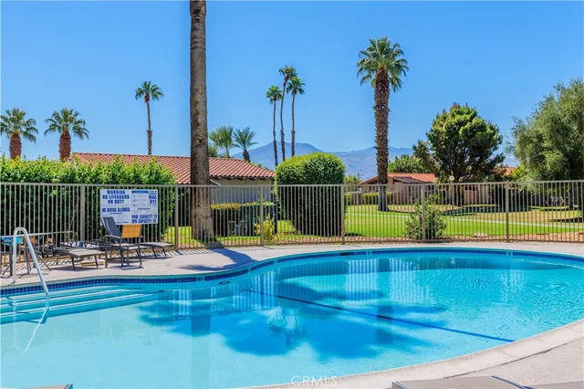 a view of a swimming pool with a lounge chairs