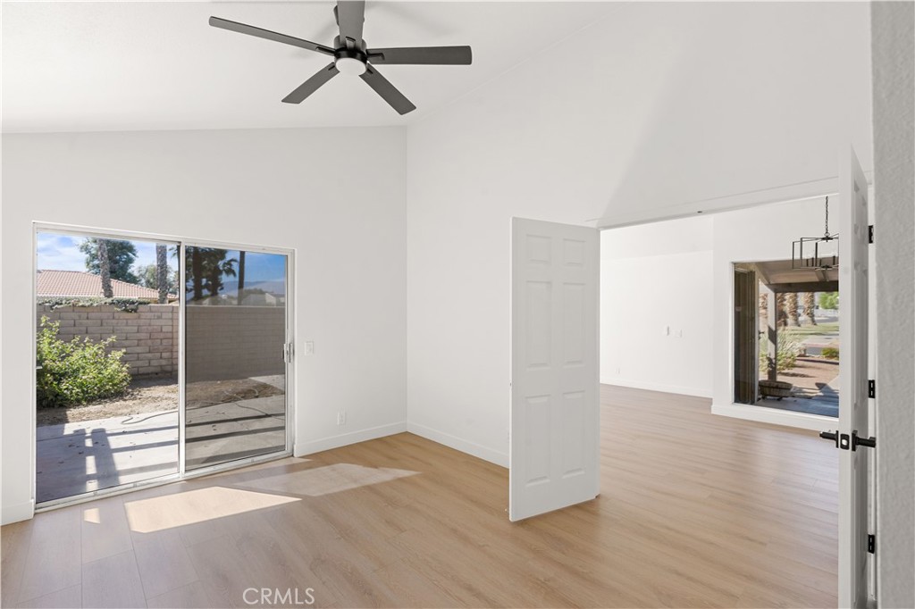 82151 Waring Way Indio, CA 92201 - Photo 7 of 22 a view of an empty room with wooden floor and a window