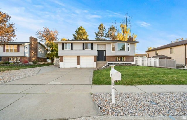 495 Creek View Road Centerville, UT 84014 - Photo 1 of 1 Split foyer home featuring brick siding, driveway, a chimney, and an attached garage