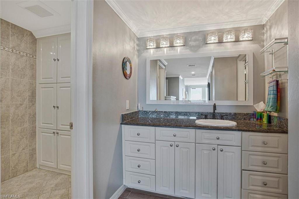 4031 Gulf Shore Boulevard North, Unit 6B Naples, FL 34103 - Photo 17 of 37 Bathroom featuring vanity and crown molding