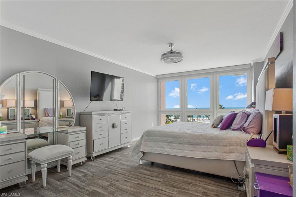 4031 Gulf Shore Boulevard North, Unit 6B Naples, FL 34103 - Photo 18 of 37 Bedroom with crown molding and wood finished floors