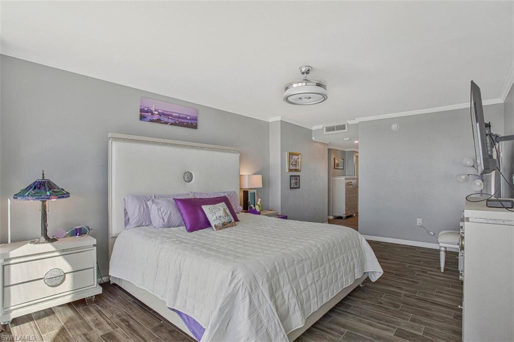 4031 Gulf Shore Boulevard North, Unit 6B Naples, FL 34103 - Photo 19 of 37 Bedroom with wood finish floors and crown molding