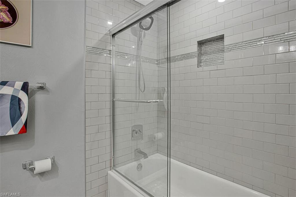 4031 Gulf Shore Boulevard North, Unit 6B Naples, FL 34103 - Photo 21 of 37 Full bath with shower / bath combination with glass door