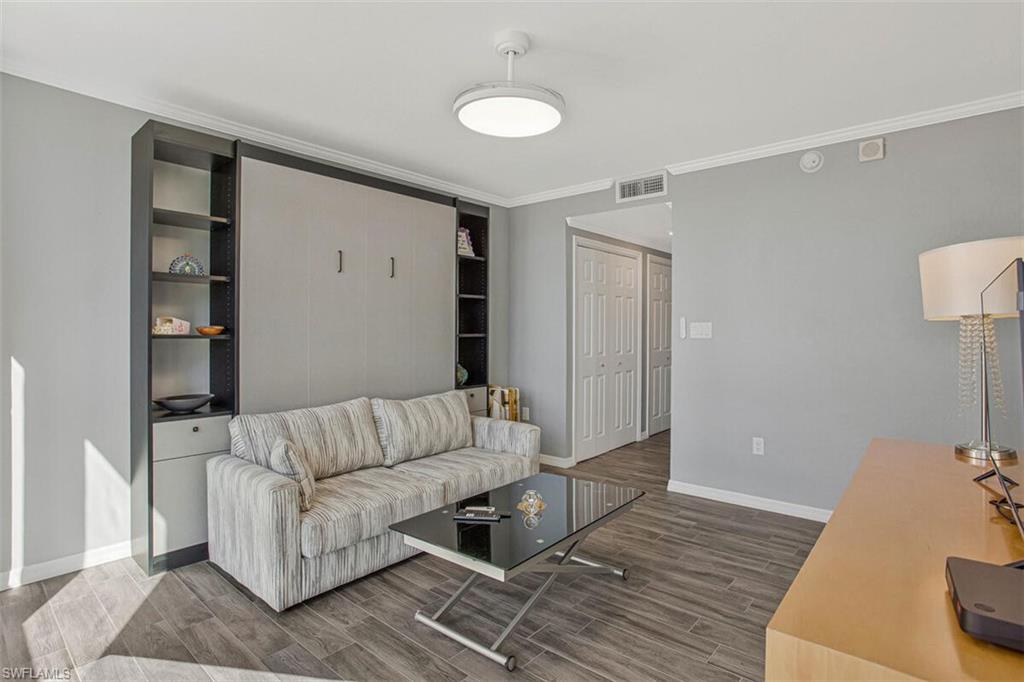 4031 Gulf Shore Boulevard North, Unit 6B Naples, FL 34103 - Photo 23 of 37 Living room with wood finish floors and crown molding