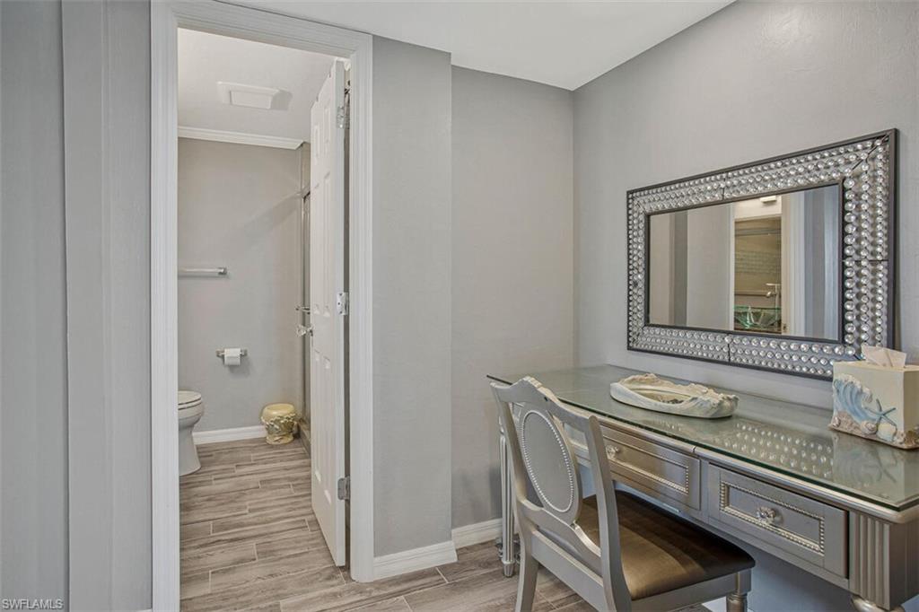 4031 Gulf Shore Boulevard North, Unit 6B Naples, FL 34103 - Photo 24 of 37 Bathroom with wood finish floors and vanity