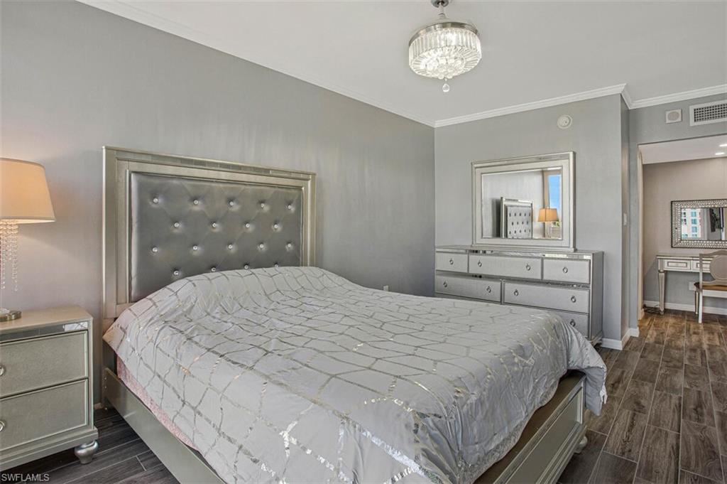 4031 Gulf Shore Boulevard North, Unit 6B Naples, FL 34103 - Photo 27 of 37 Bedroom featuring wood finish floors and crown molding