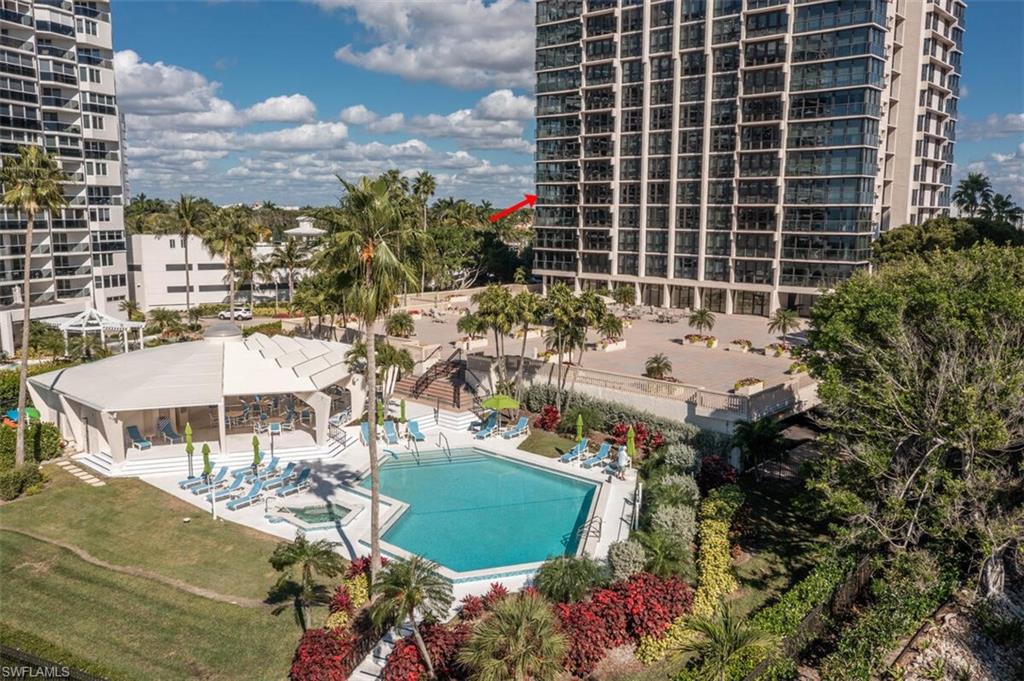 4031 Gulf Shore Boulevard North, Unit 6B Naples, FL 34103 - Photo 3 of 37 Community pool with a patio area, a lawn, and a jacuzzi