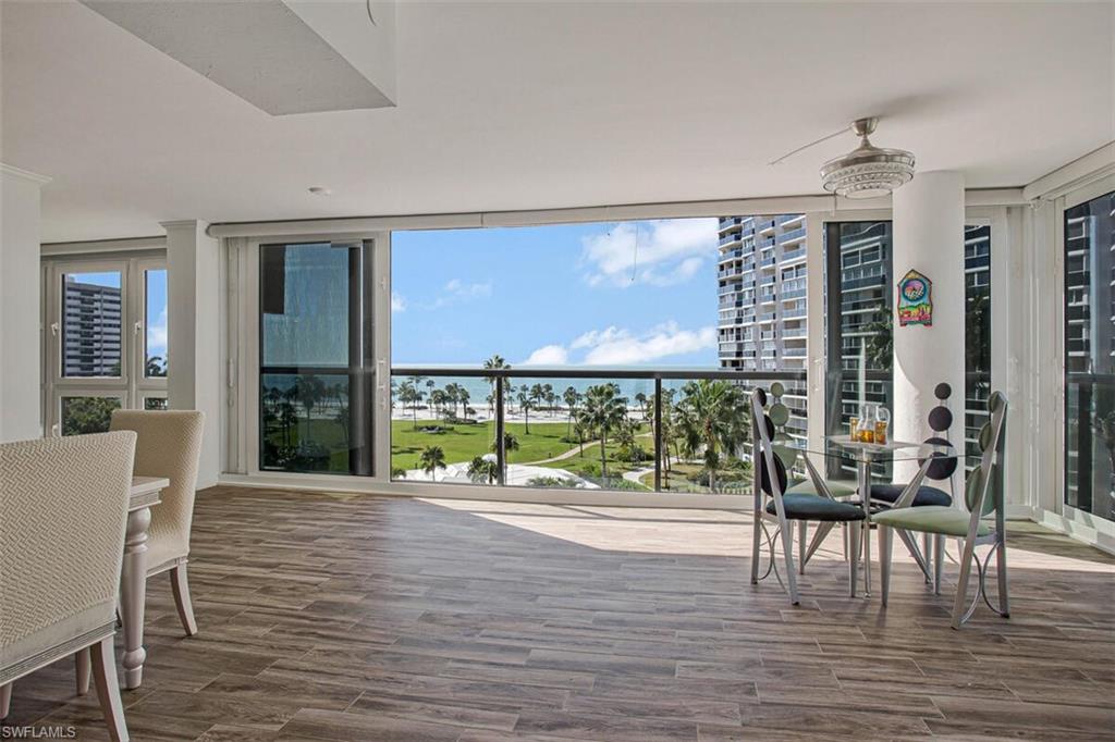 4031 Gulf Shore Boulevard North, Unit 6B Naples, FL 34103 - Photo 31 of 37 Balcony featuring a ceiling fan and outdoor dining space