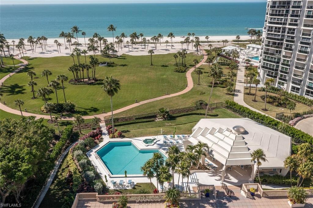 4031 Gulf Shore Boulevard North, Unit 6B Naples, FL 34103 - Photo 34 of 37 Drone / aerial view of a pool and extended coastline