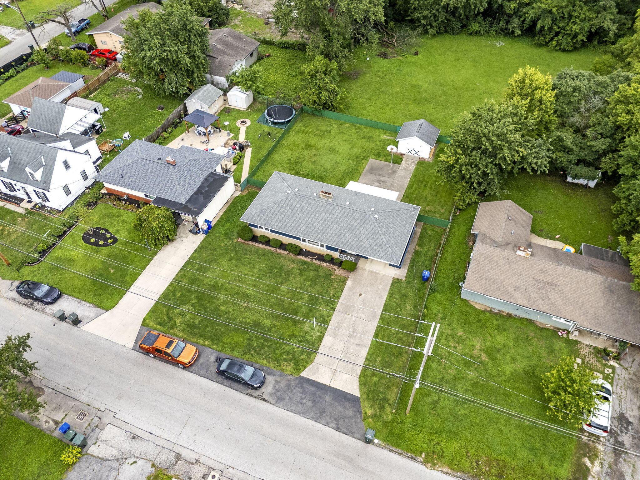 3496 Wicklow Road Columbus, OH 43204 - Photo 45 of 53 Ranch-style residence featuring a gray shingle roof, a paved driveway, and a spacious front lawn