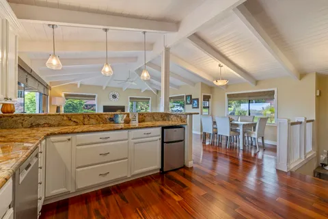 a kitchen with lots of counter top space and wooden floor