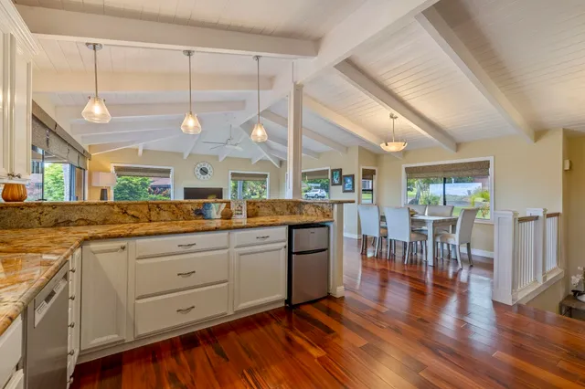 a kitchen with lots of counter top space and wooden floor