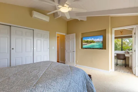 a bedroom with a bed and a painting on the wall