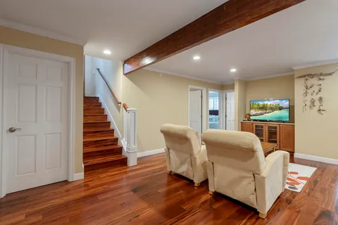 a living room with furniture and a wooden floor