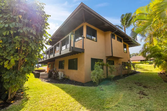 an aerial view of a house with garden space and street view